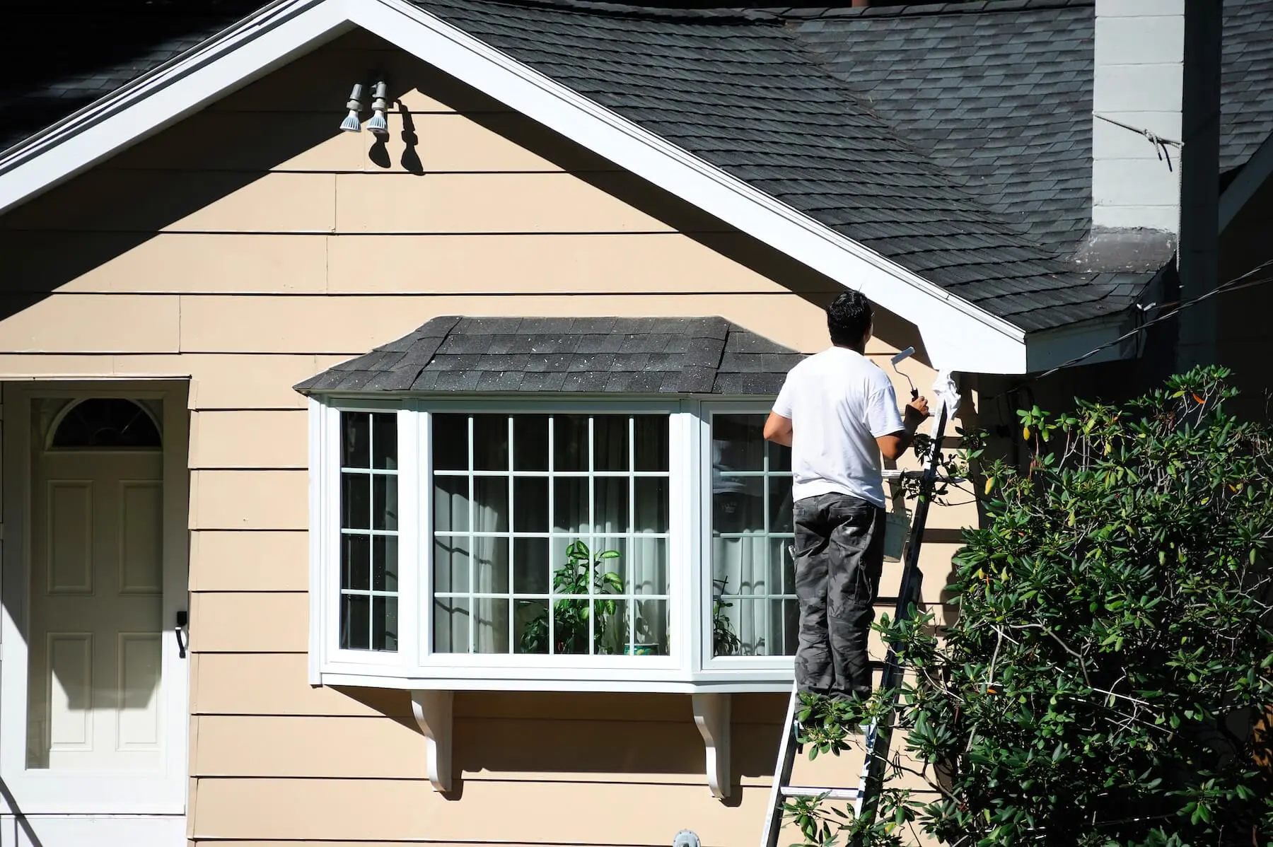 Exterior painting in progress on a New Hampshire home in optimal painting weather