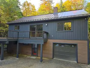 Exterior house painting and deck staining on a Lake Sunapee home