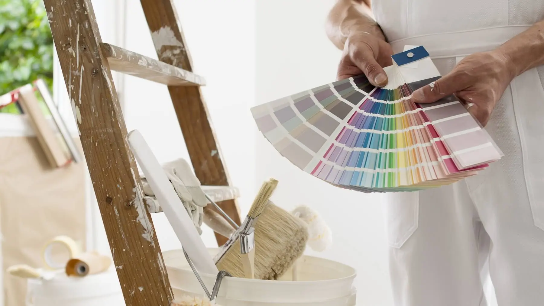 Interior paint color swatches taped to a wall in a New Hampshire home