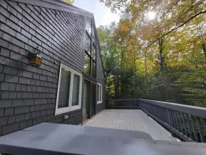Exterior house painting with crisp trim in a Sunapee NH backyard