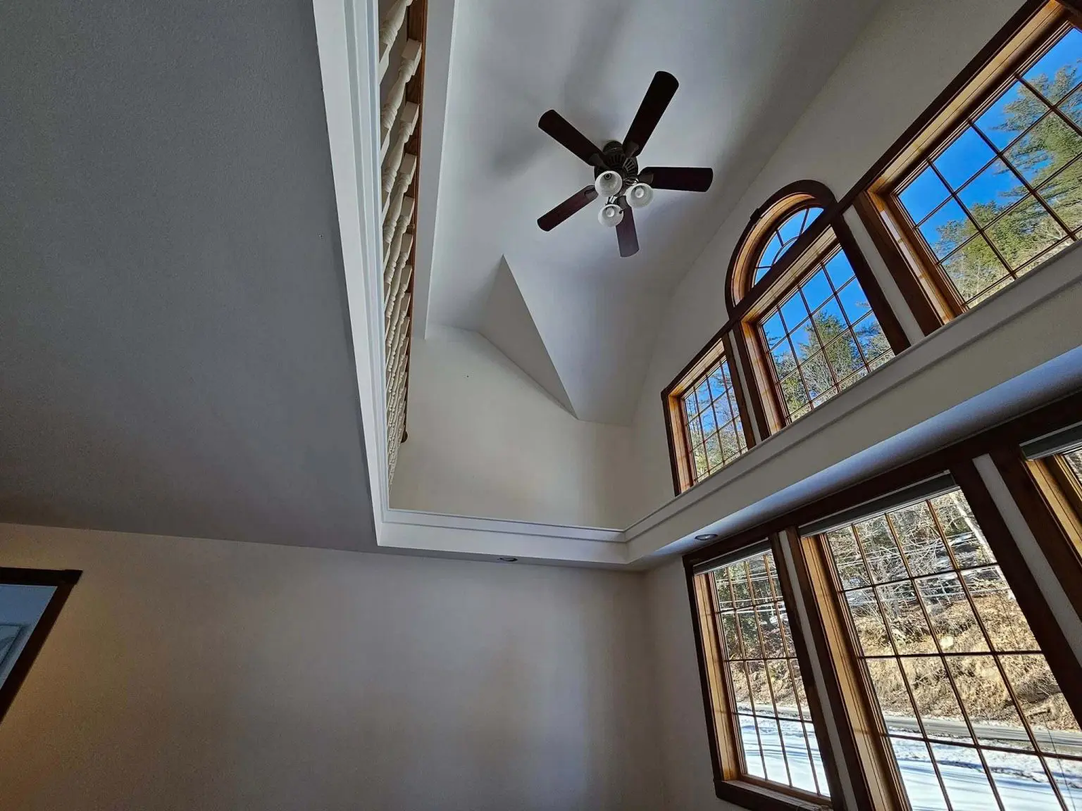 Painter cutting in crisp ceiling line for interior painting in Sunapee NH