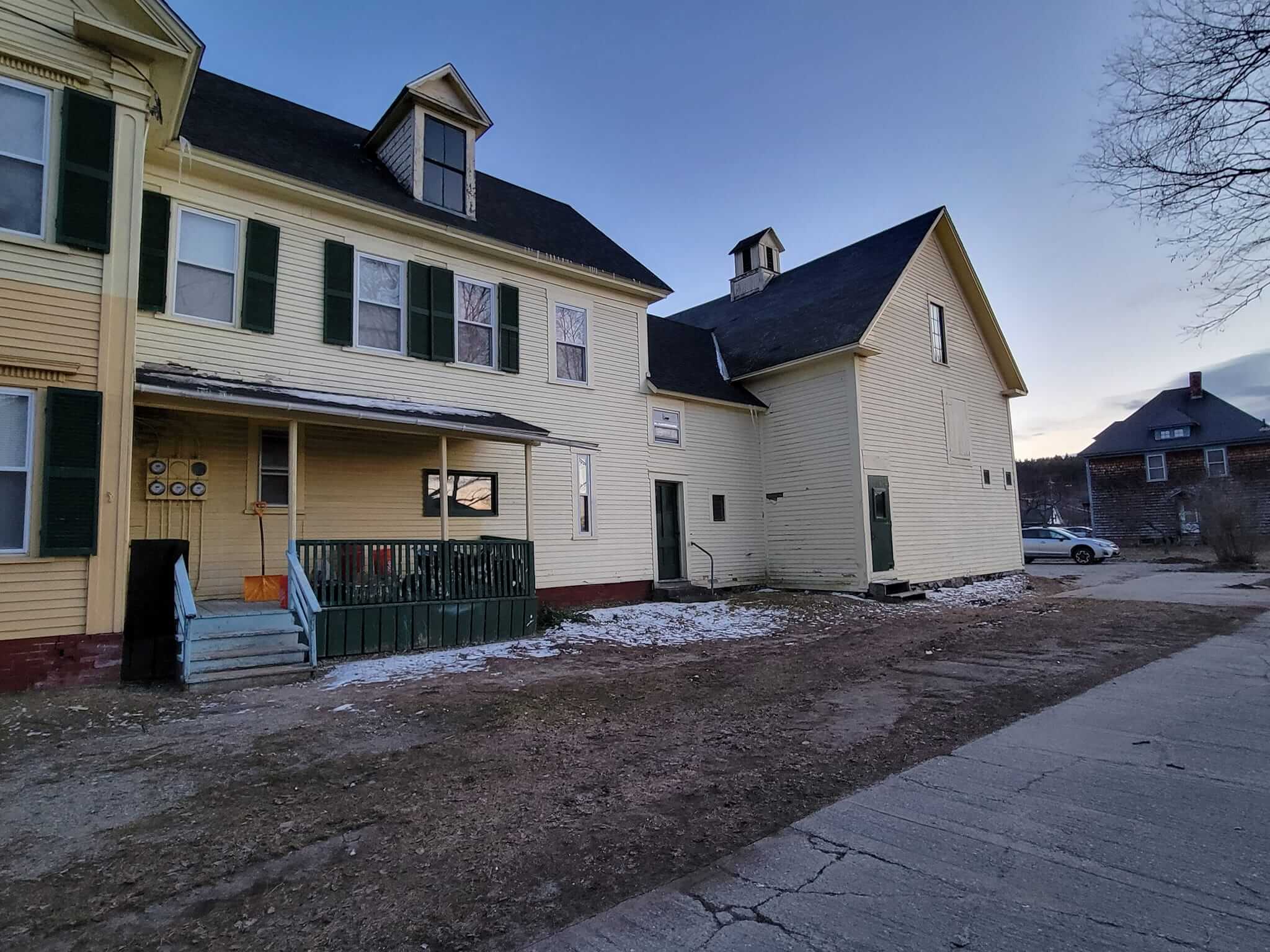 Exterior house painting with crisp trim in a Sunapee NH front