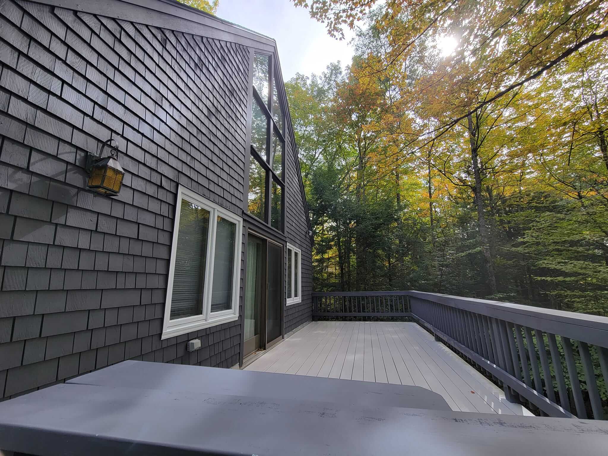 Exterior house painting with crisp trim in a Sunapee NH backyard