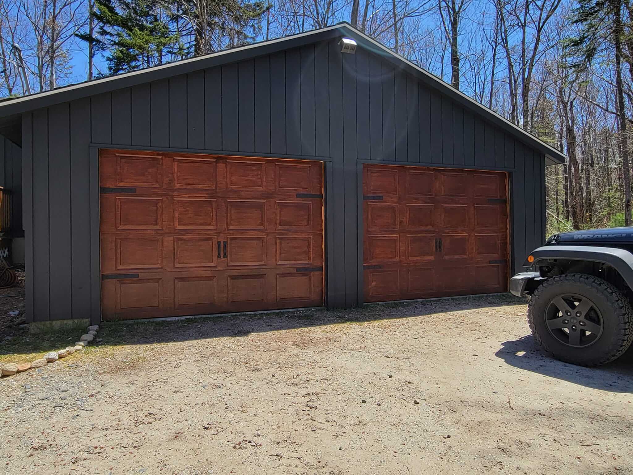 Exterior house painting with crisp trim in a Sunapee NH garage door