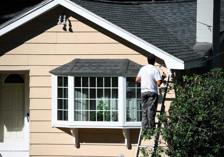 Exterior painting in progress on a New Hampshire home in optimal painting weather