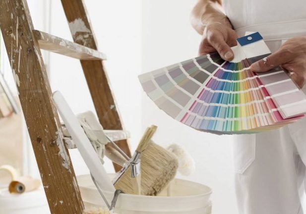 Interior paint color swatches taped to a wall in a New Hampshire home