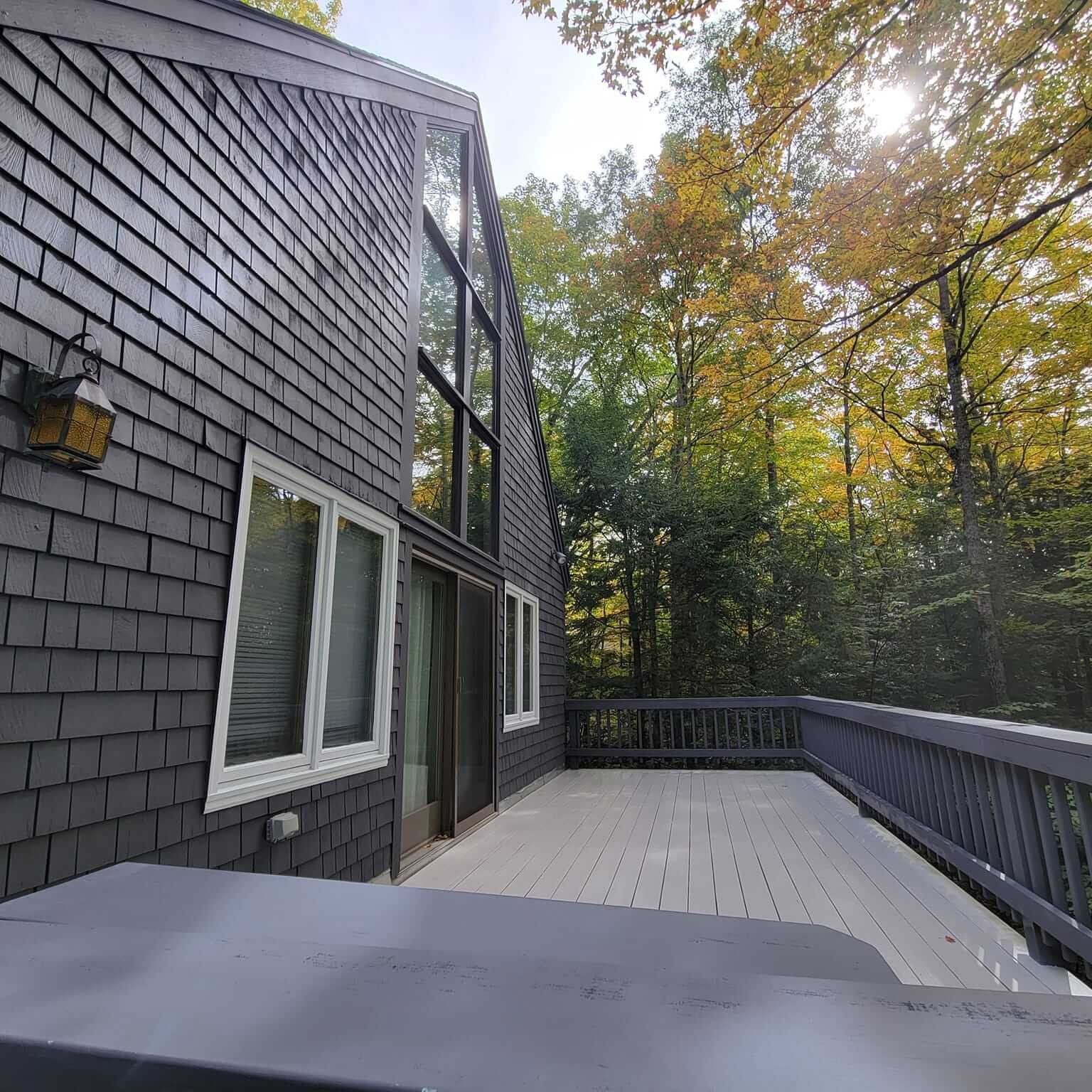 Exterior house painting with crisp trim in a Sunapee NH backyard